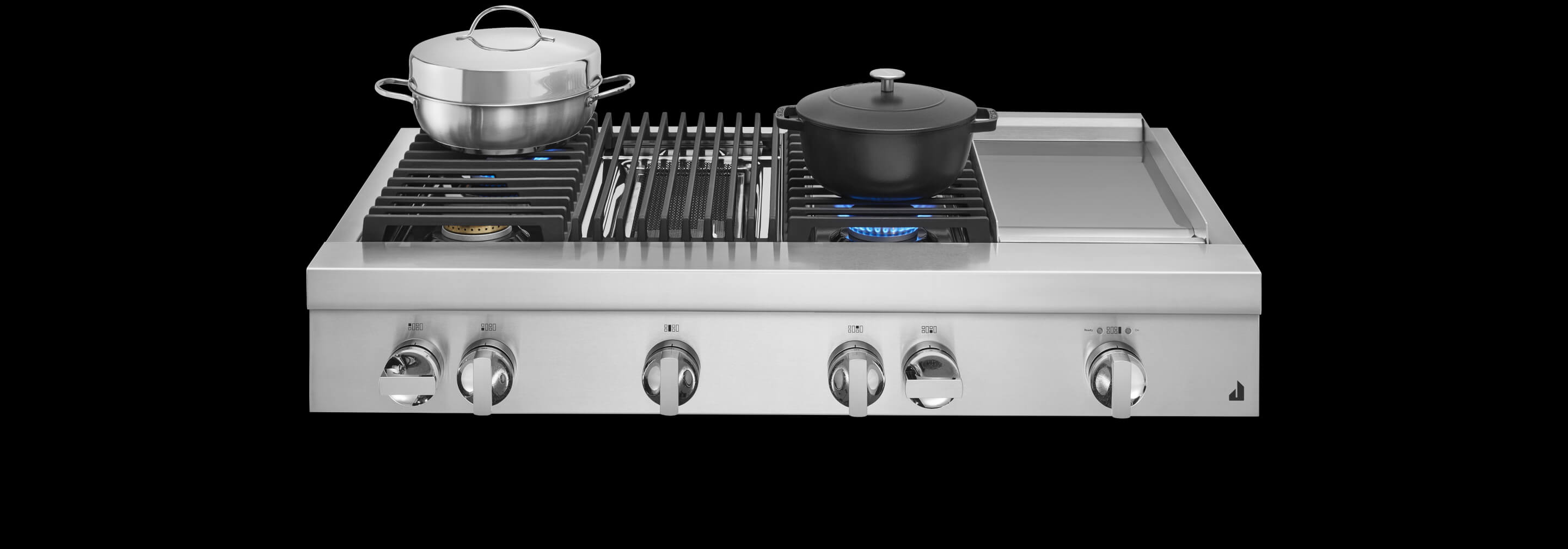 A JennAir® Professional-Style Range in NOIR™ Design, with stainless steel and cast iron pans atop lit burners.