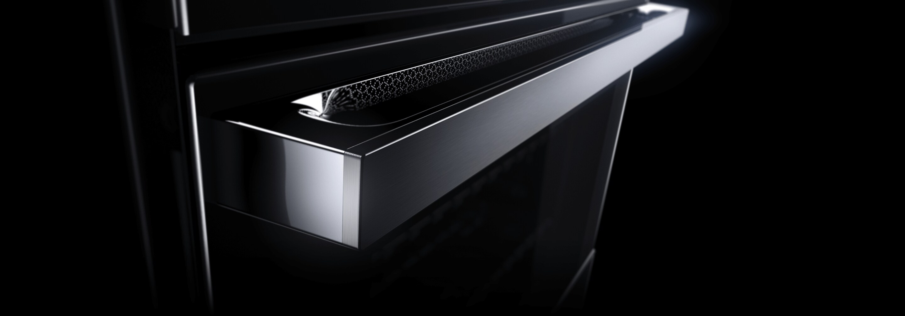 The LCD screen and handle of a JennAir® NOIR™ Design Wall Oven.