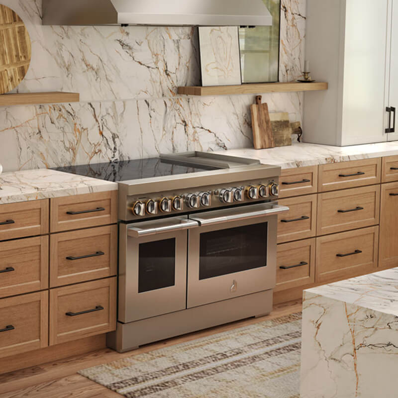 An induction range in an open-concept luxury kitchen keeps the space comfortable with minimal ambient heat during cooking.