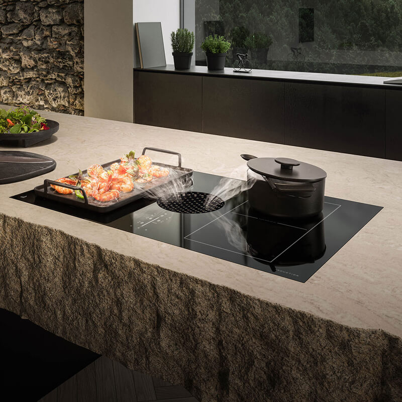 An induction cooktop flush-mounted into a luxury kitchen countertop for a seamless, modern look.
