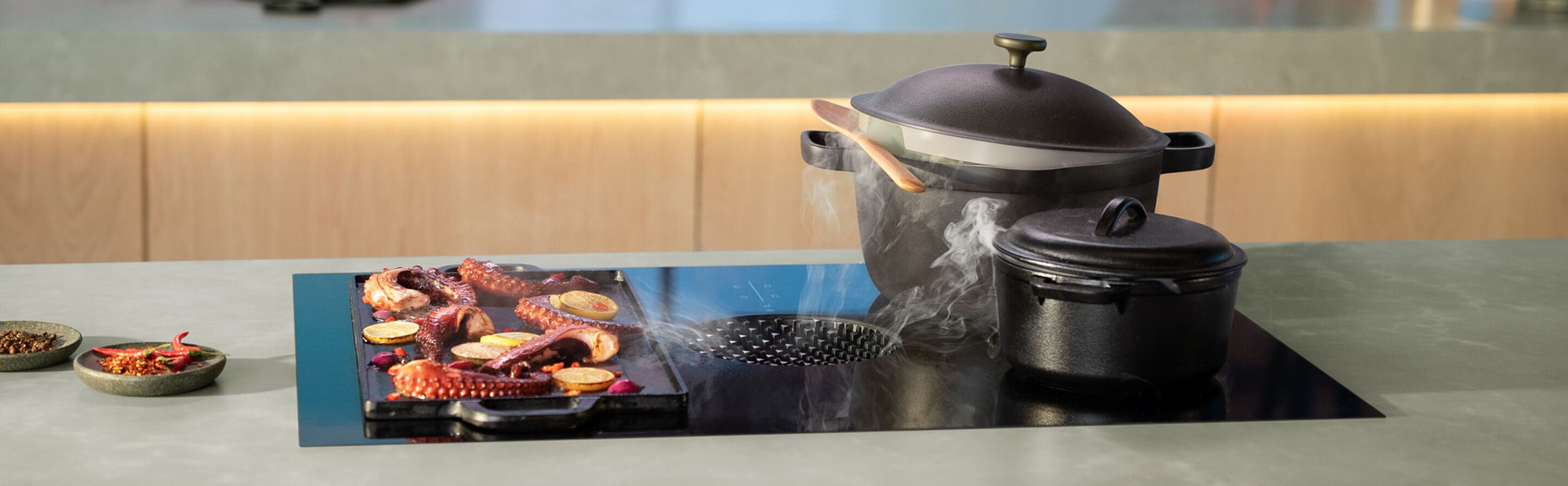 A downdraft induction cooktop in a modern, luxury kitchen.