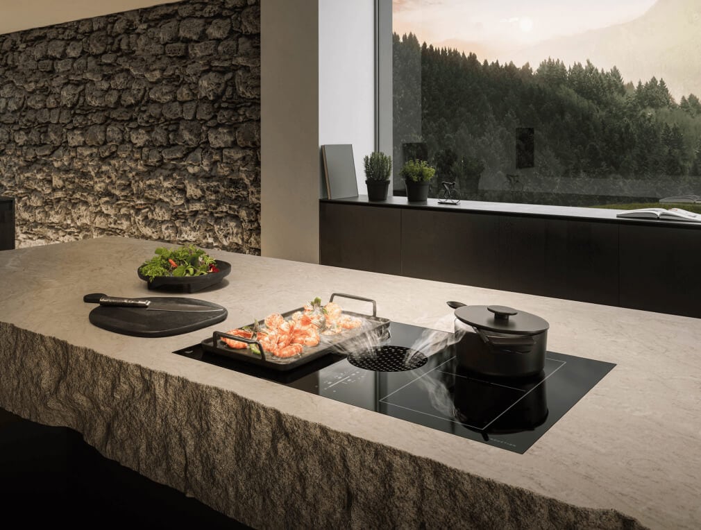 Dinner being prepared on a luxury induction downdraft cooktop.