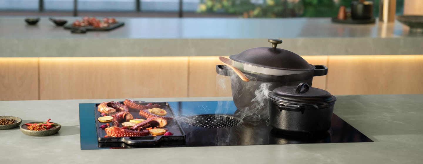 Induction-ready pots on an induction downdraft cooktop.