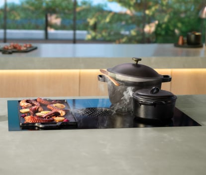 Induction-ready pots on an induction downdraft cooktop.