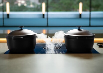 Induction-compatible cookware on a luxury induction cooktop.