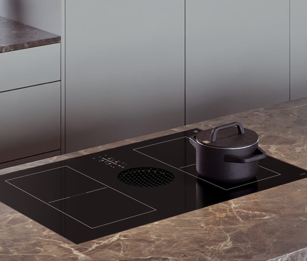 A pot on a JennAir® Induction Downdraft Cooktop.