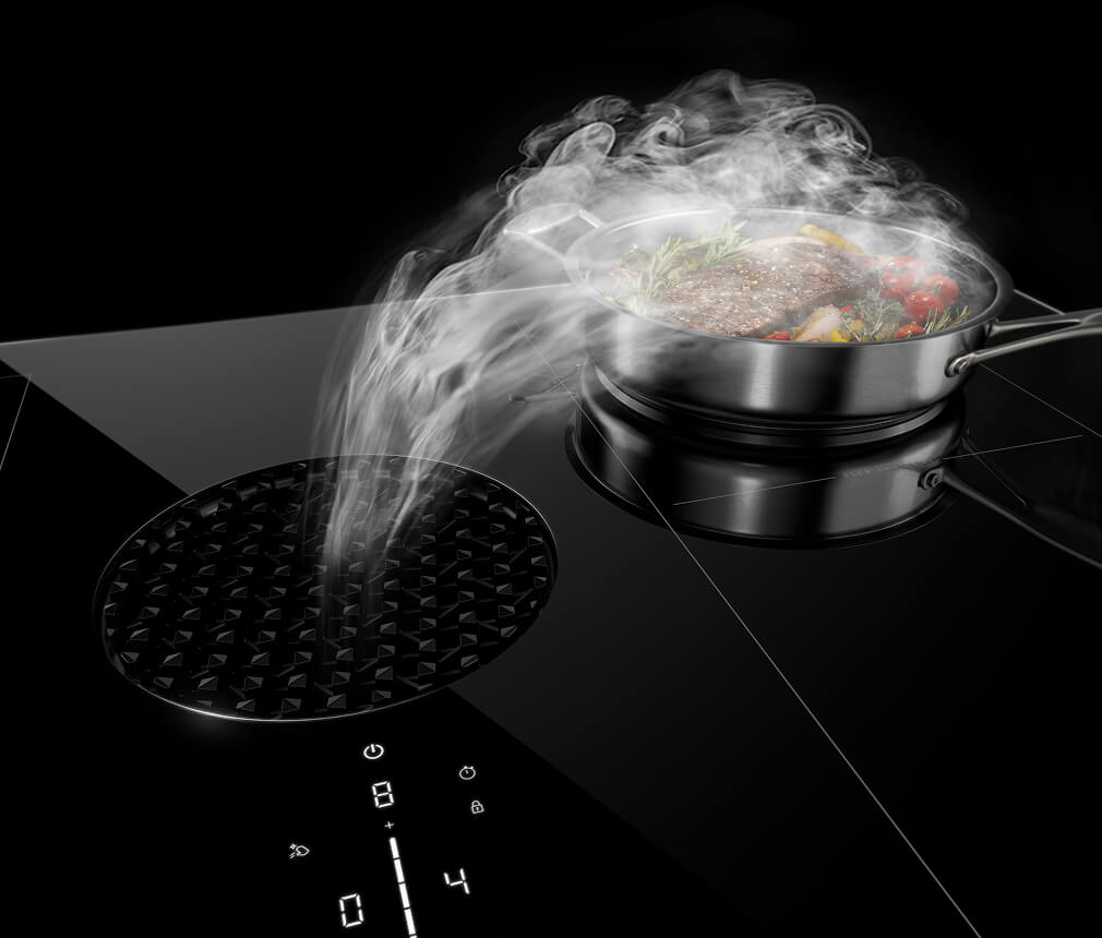 Steam going into the vents on a JennAir® Induction Downdraft Cooktop.