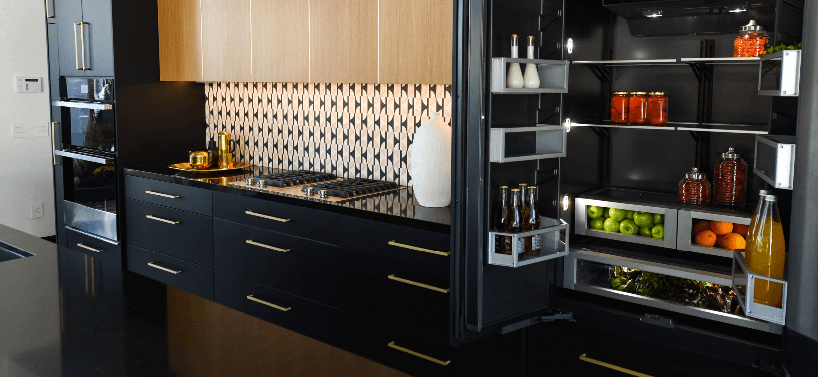 Open JennAir Refrigerators in a dark, modern kitchen. 