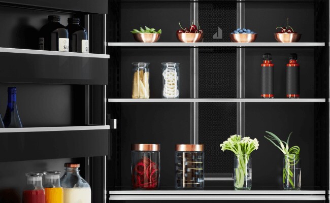 The interior of a JennAir Refrigerator filled with high-end foods and ingredients.  The interior of a JennAir Refrigerator filled with high-end foods and ingredients.