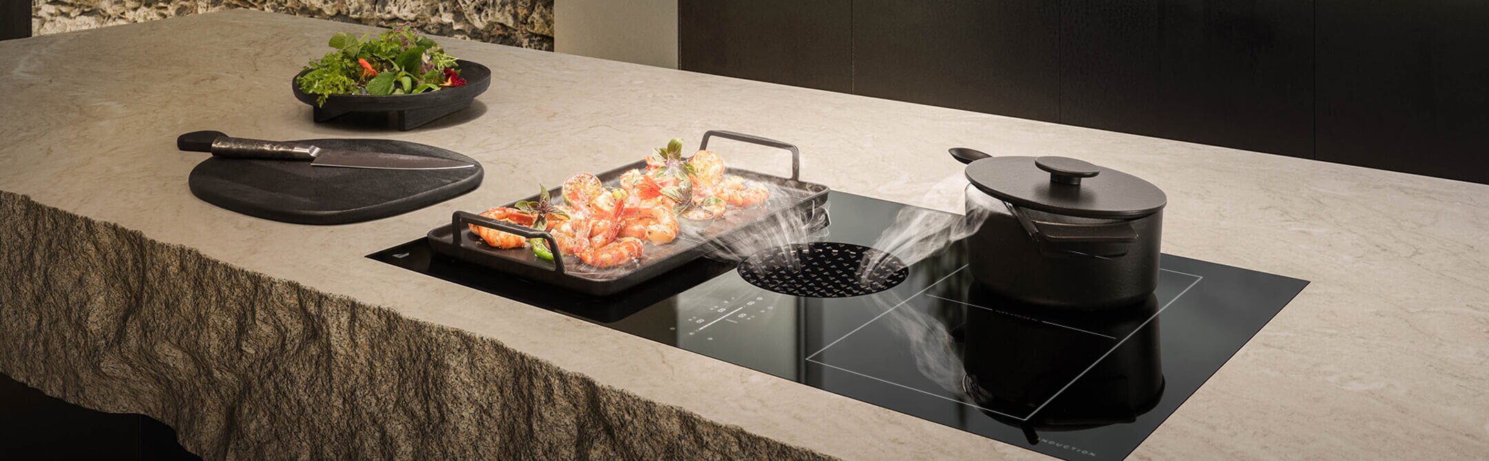 An induction downdraft cooktop on a floating island.