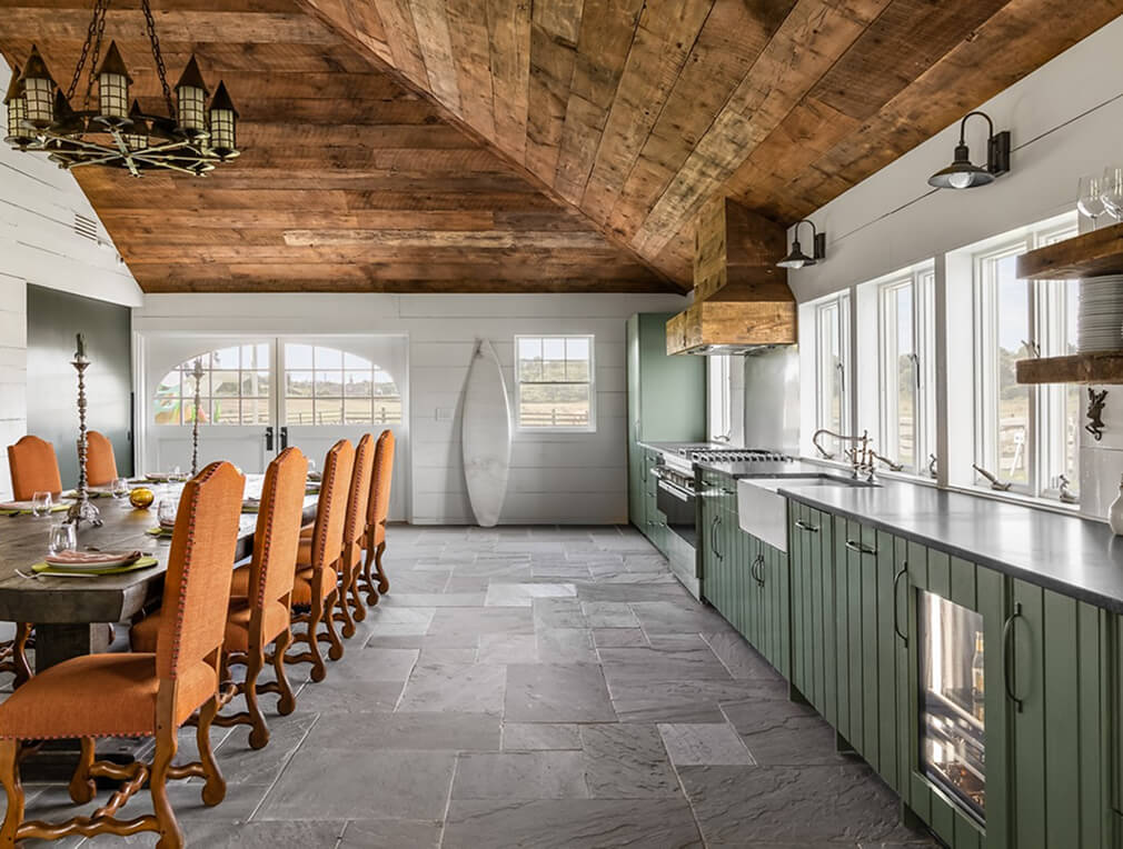 An open kitchen with a large dining table set for entertaining.