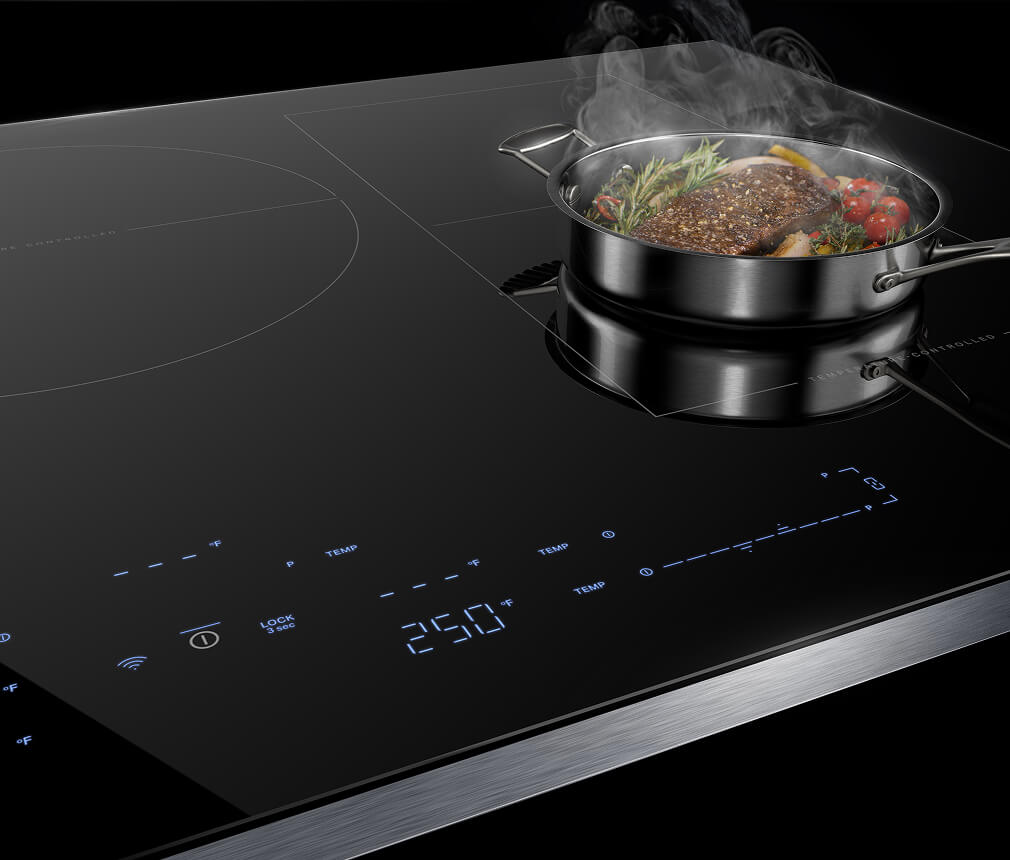 A filet and vegetables cooking on top of a burner on the JennAir® Induction Cooktop with Temperature Controlled Cooking. 