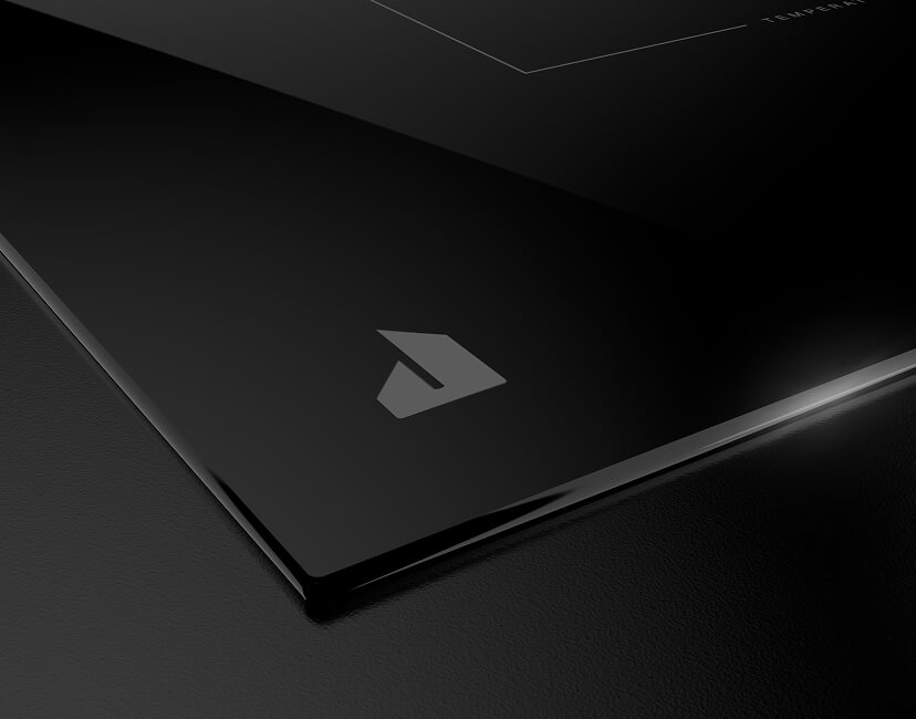 The JennAir brand badge on the JennAir® Induction Cooktop with Temperature Controlled Cooking.