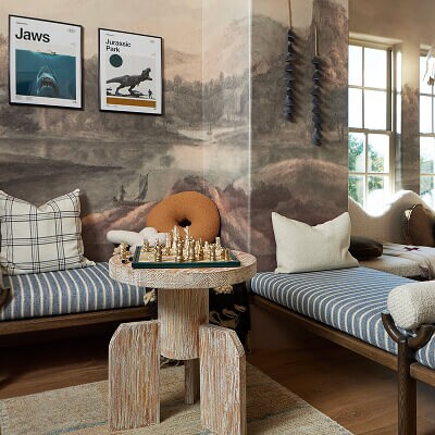 Two benches placed by a table with a chess set.