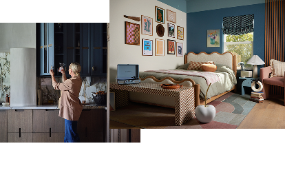 A person placing a glass into a blue cabinet. A bright room with prints on the wall and a record player at the foot of the bed. A person placing a glass into a blue cabinet. A bright room with prints on the wall and a record player at the foot of the bed.