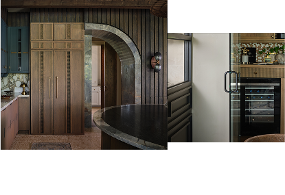 A dark kitchen with blue and brown cabinets. A JennAir® wine cellar filled with drinks. A dark kitchen with blue and brown cabinets. A JennAir® wine cellar filled with drinks.