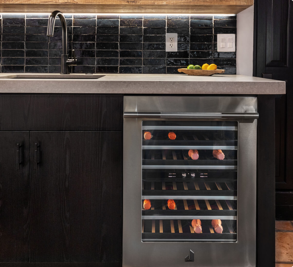 A close up of a JennAir® Undercounter Wine Cellar in a luxury kitchen. A close up of a JennAir® Undercounter Wine Cellar in a luxury kitchen.