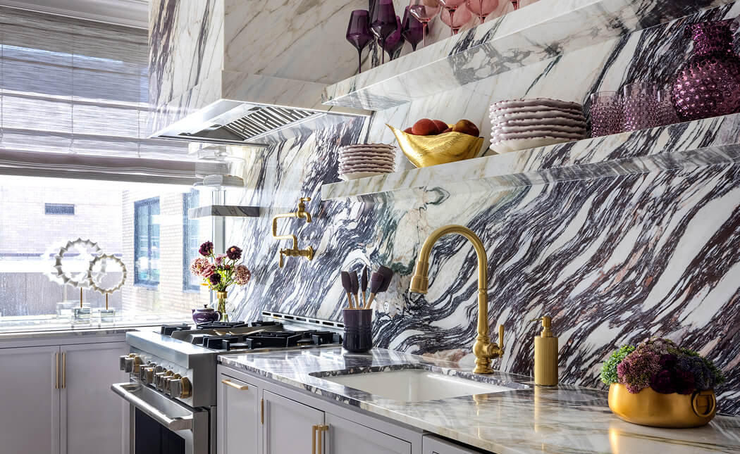 A marble kitchen with JennAir® appliances, designed by Corey Damen Jenkins.
