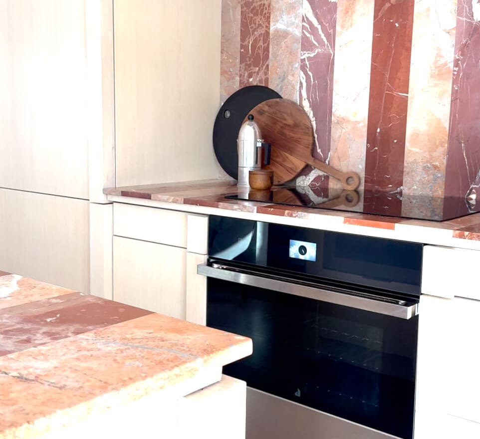 A JennAir® Wall Oven in the NOIR™ Design Expression with the bold backsplash in the kitchen.