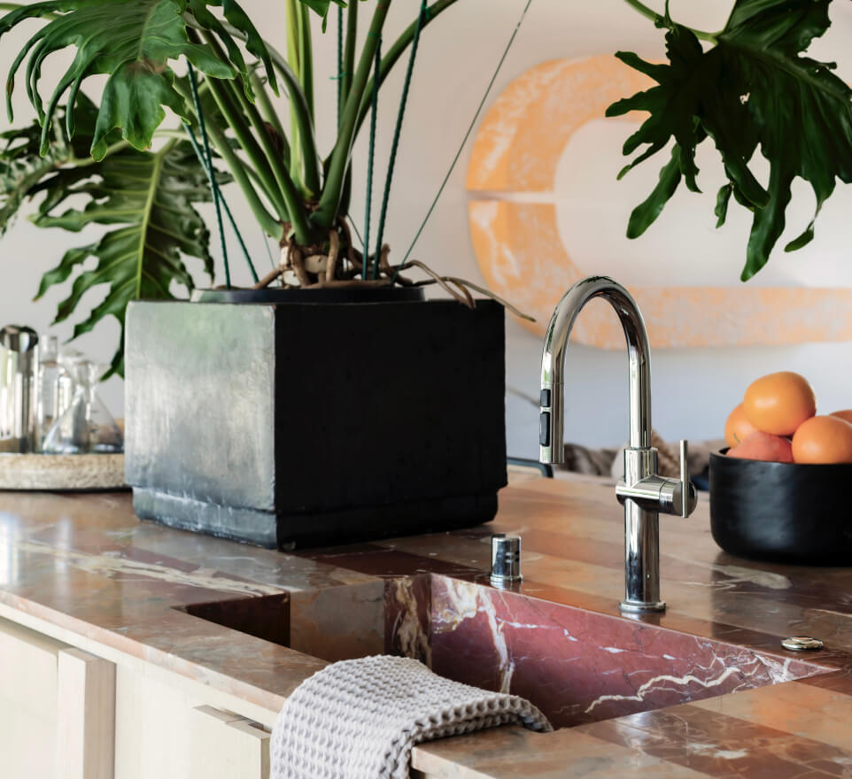 The sink on the island of the kitchen.