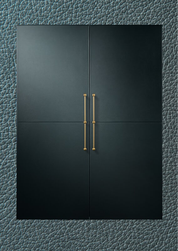 A pair of JennAir® Columns fitted with Mystic Cuts Leather Panels and custom handles on a background of the leather’s texture.