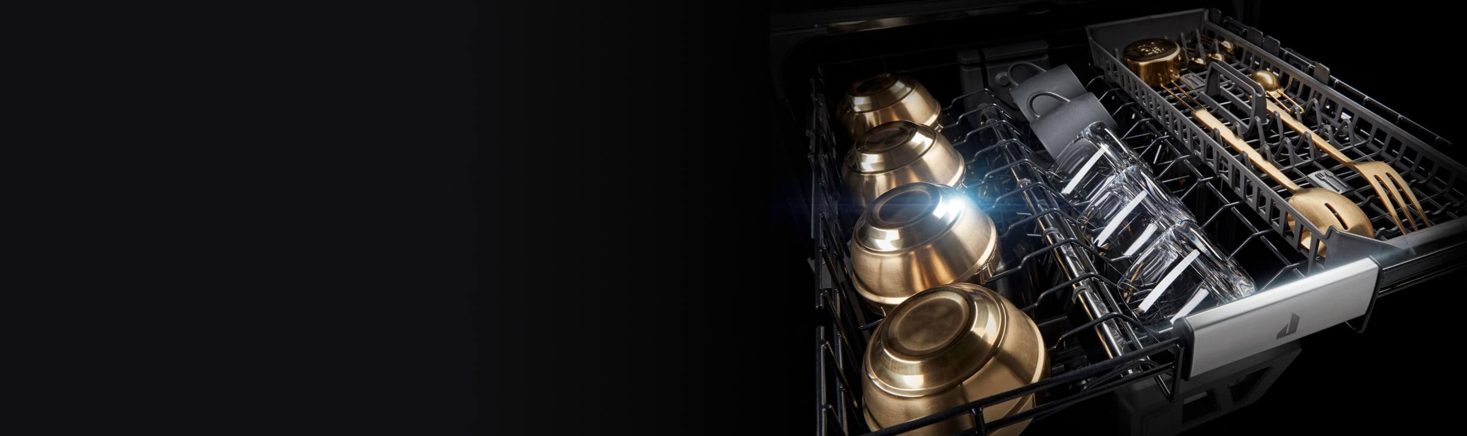 Glasses and dishware in the upper rack of a JennAir Dishwasher.