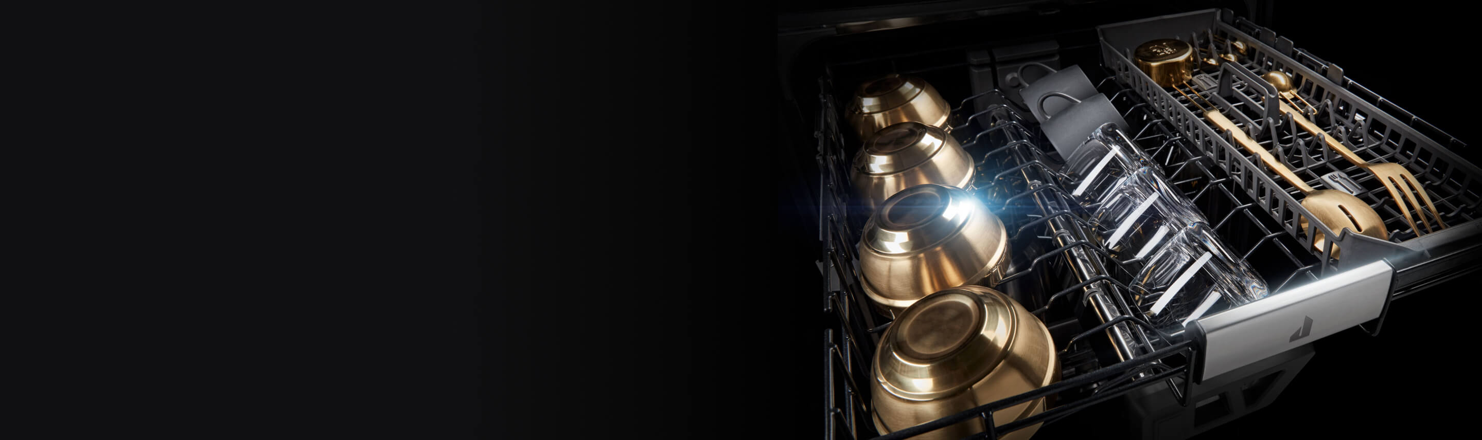 Glasses and dishware in the upper rack of a JennAir Dishwasher.