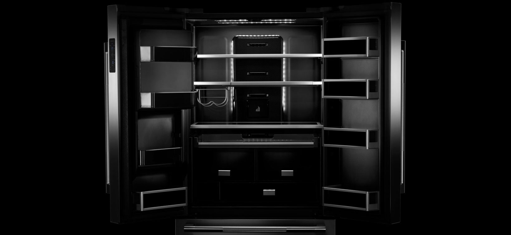 An open JennAir refrigerator. Showing the Daring Obsidian Interior.  An open JennAir refrigerator. Showing the Daring Obsidian Interior.
