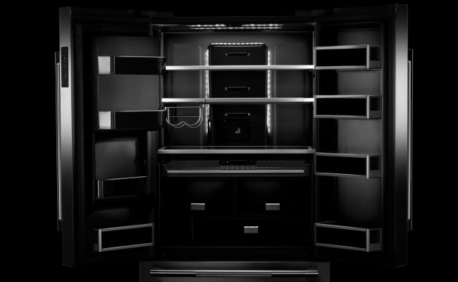 An open JennAir refrigerator. Showing the Daring Obsidian Interior.  An open JennAir refrigerator. Showing the Daring Obsidian Interior.
