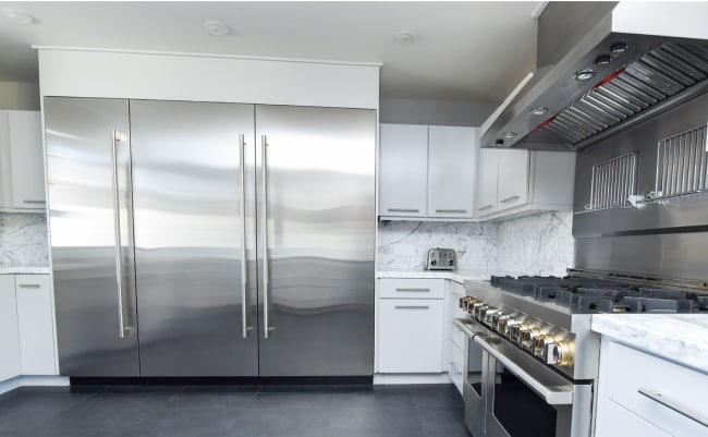 JennAir column refrigerators and freezers in a bright modern kitchen with a JennAir range and ventilation system.  JennAir column refrigerators and freezers in a bright modern kitchen with a JennAir range and ventilation system.