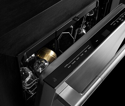 An open dishwasher loaded with dishes.