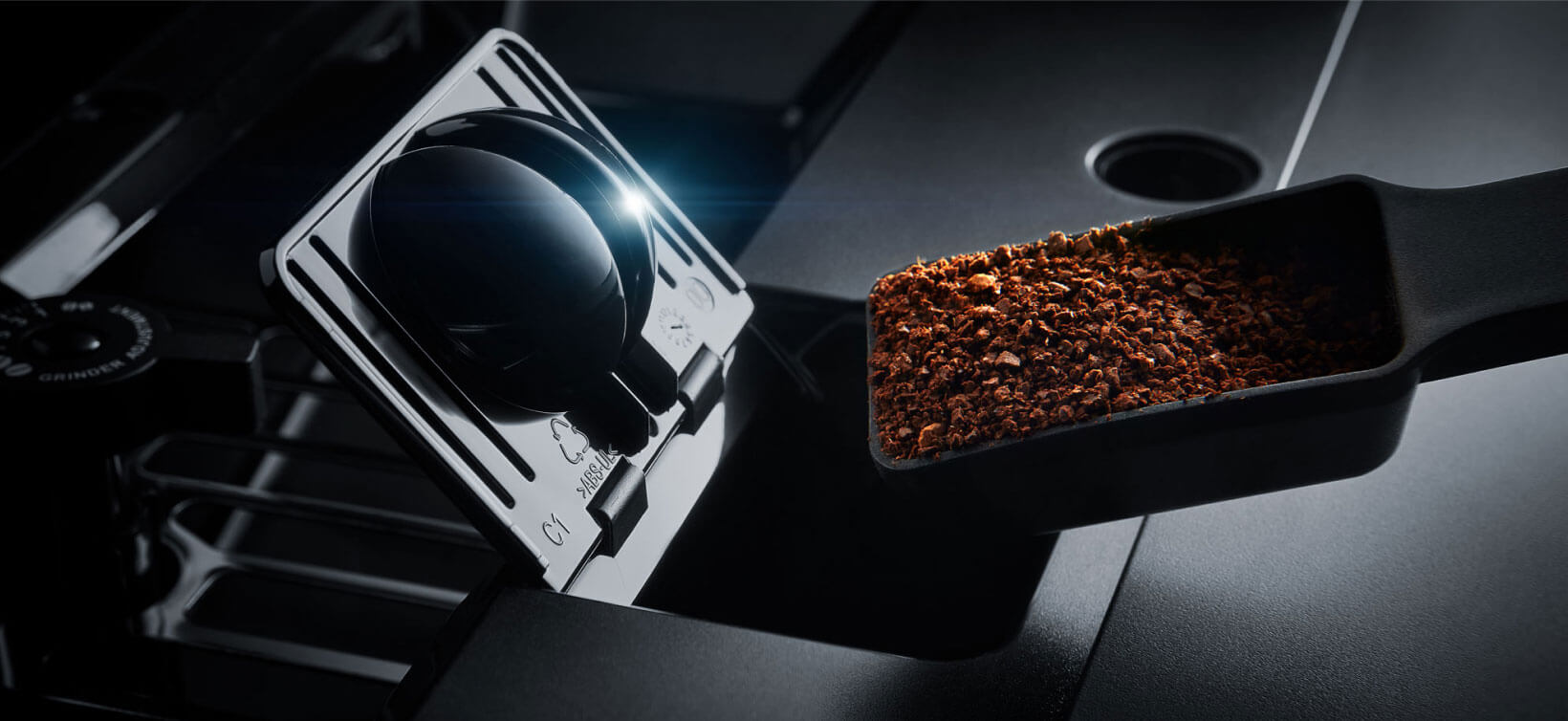 Coffee grounds being poured into a JennAir Built-In Coffee Machine. 