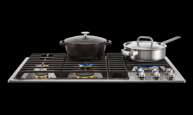 Two pots heating on a JennAir® gas cooktop