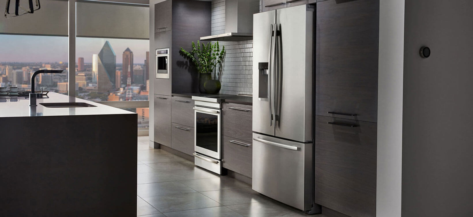 A JennAir freestanding refrigerator in a modern high-rise condo.