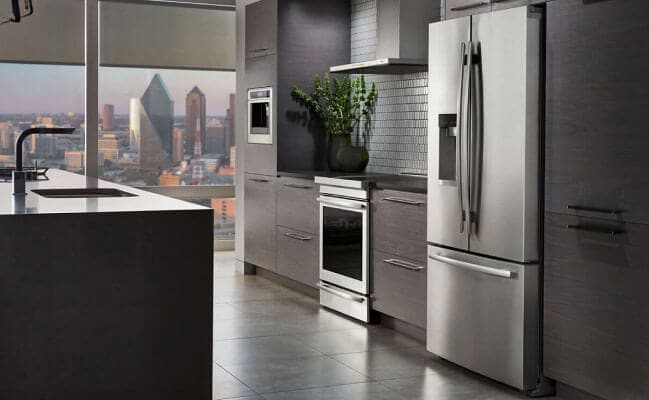 A JennAir freestanding refrigerator in a modern high-rise condo.