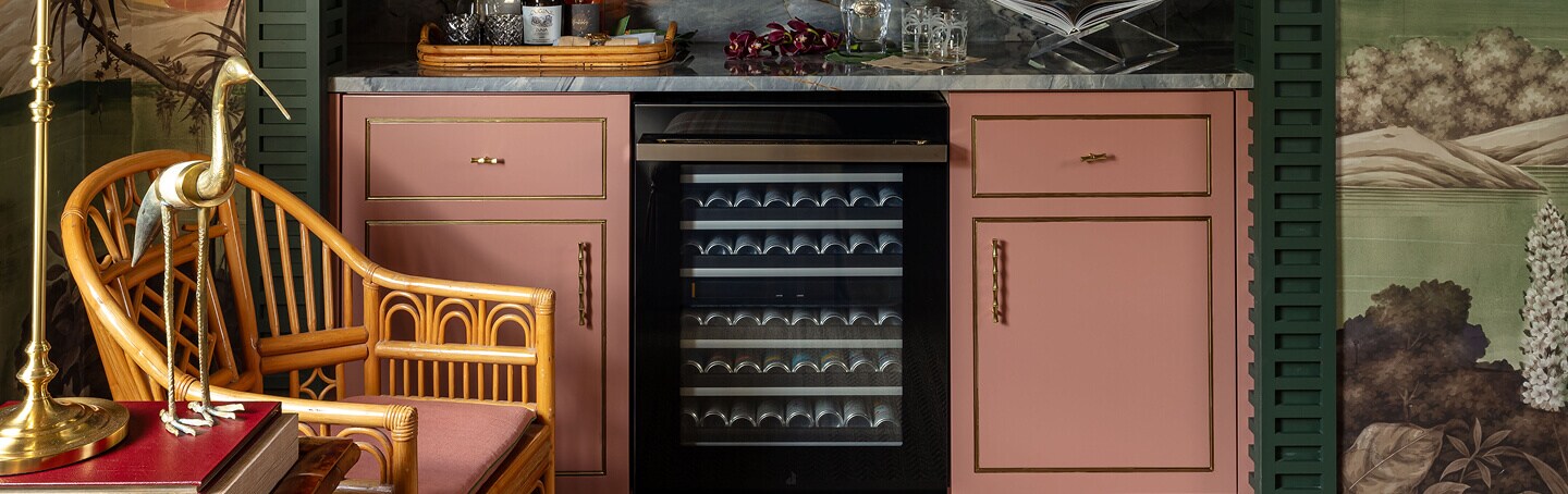 An undercounter wine refrigerator installed flush with kitchen cabinets