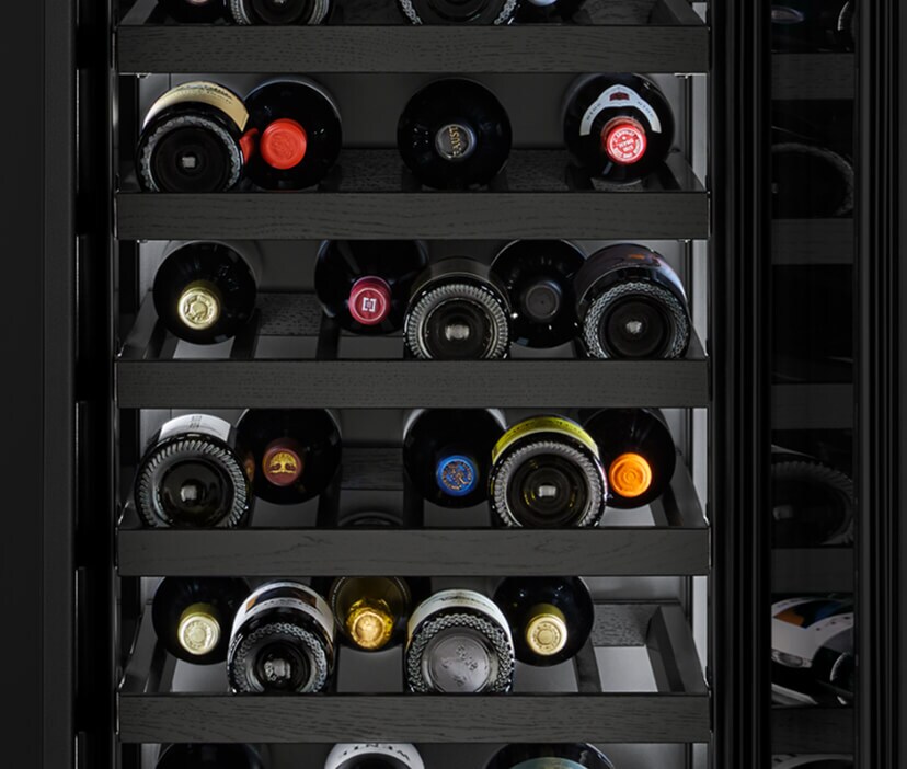 Interior of JennAir® Wine Refrigerator filled with wine bottles.