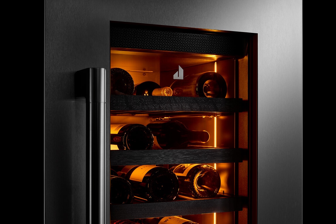 Wine bottles stored in a JennAir® Wine Column Refrigerator with humidity-controlled environment.