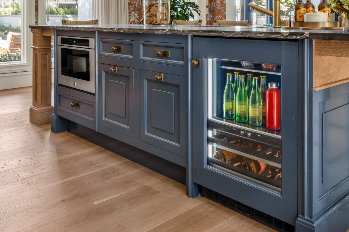 A panel-ready wine and beverage refrigerator in a kitchen island.