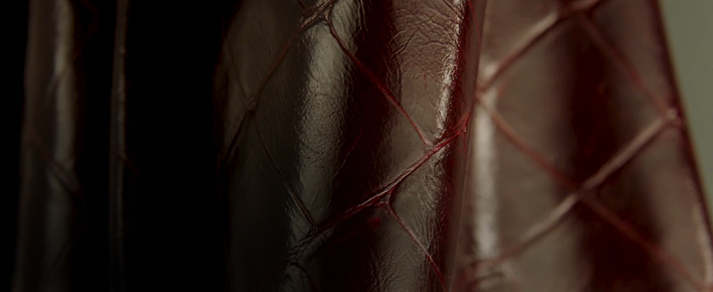  A close-up view of the texture of the burgundy Croc leather. 