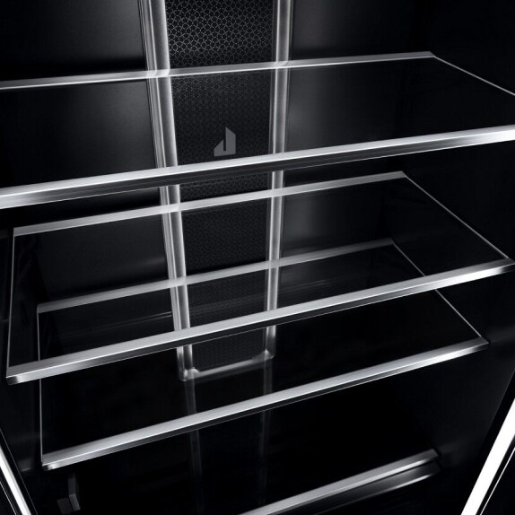 Glass shelves with metal trim in the interior of a JennAir® Column Refrigerator.