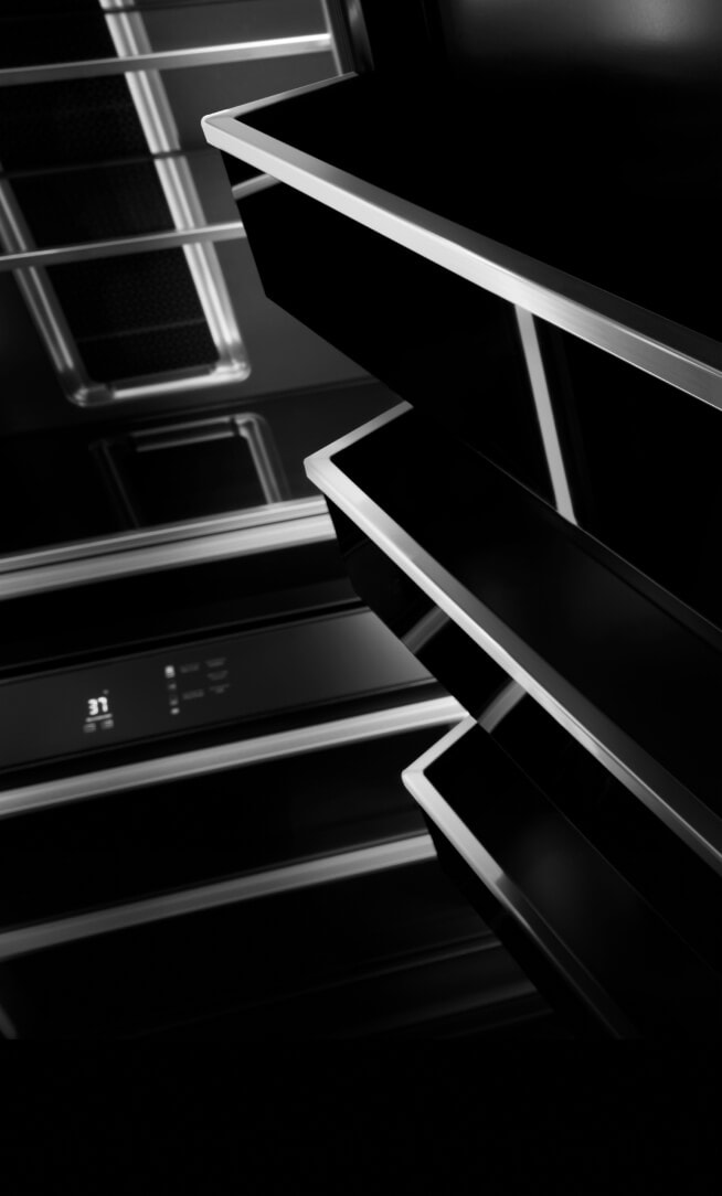 The dark-veiled door bins trimmed with metal inside a JennAir® Column. 