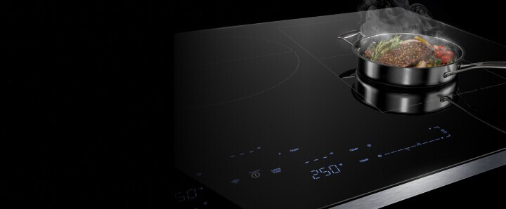 A steaming pan on an induction cooktop.