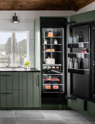 A view of the main bank of cabinets, featuring a panel-ready beverage center and a column refrigerator.