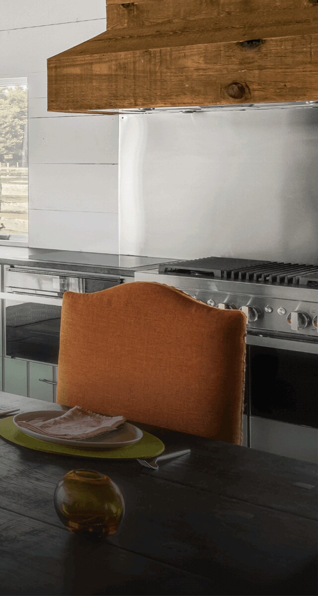 A NOIR™ Professional-Style Range in a blue kitchen.