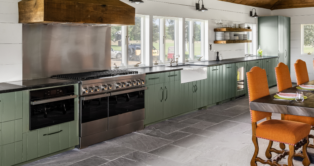 Another view of the kitchen, featuring a wall oven and range.