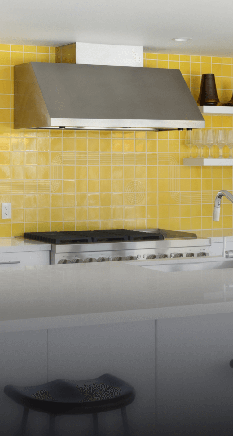 A JennAir® Professional-Style Range in a yellow kitchen.