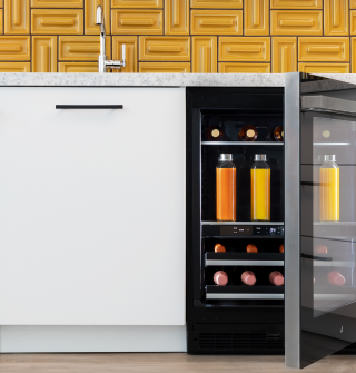 A whole-kitchen view featuring a pair of open JennAir® Columns with an Obsidian Interior.