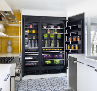 A whole-kitchen view featuring a pair of open JennAir® Columns with an Obsidian Interior.