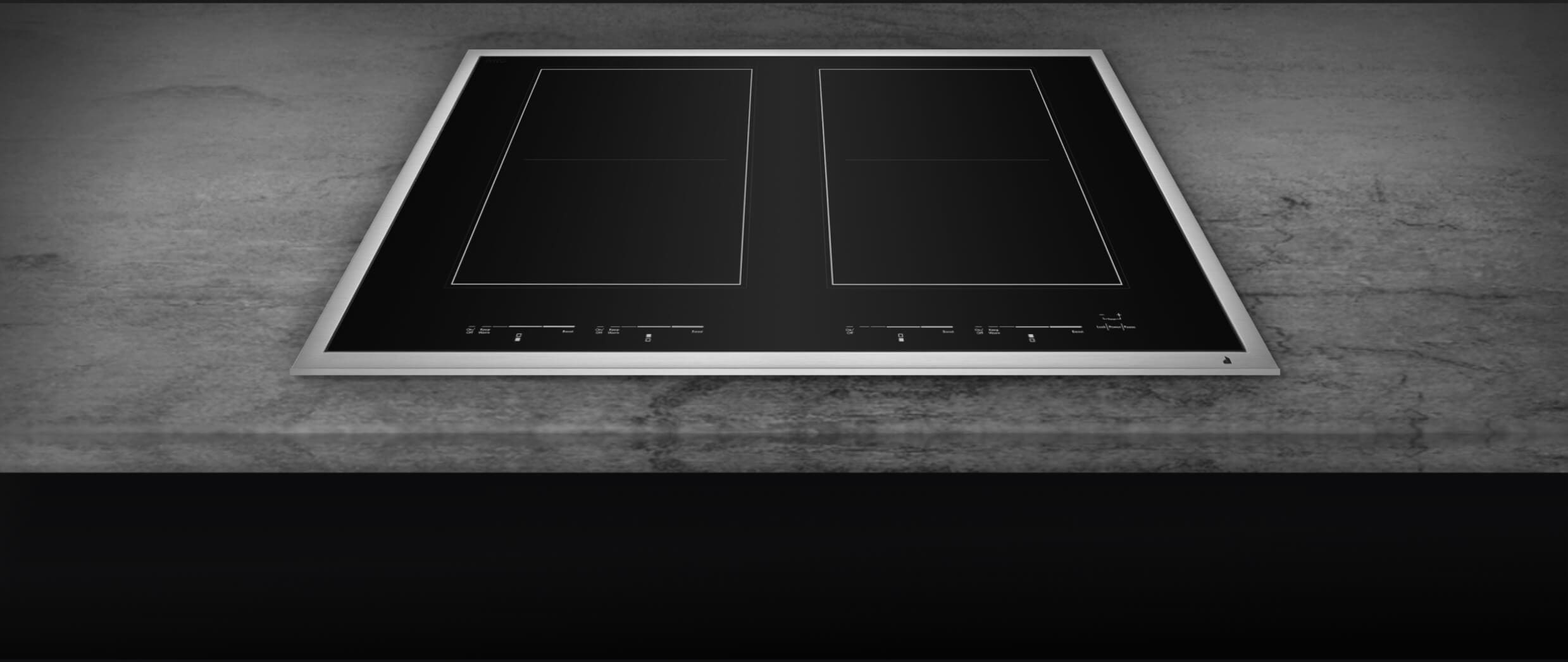 A closeup of the brushed metal frame of a cooktop.